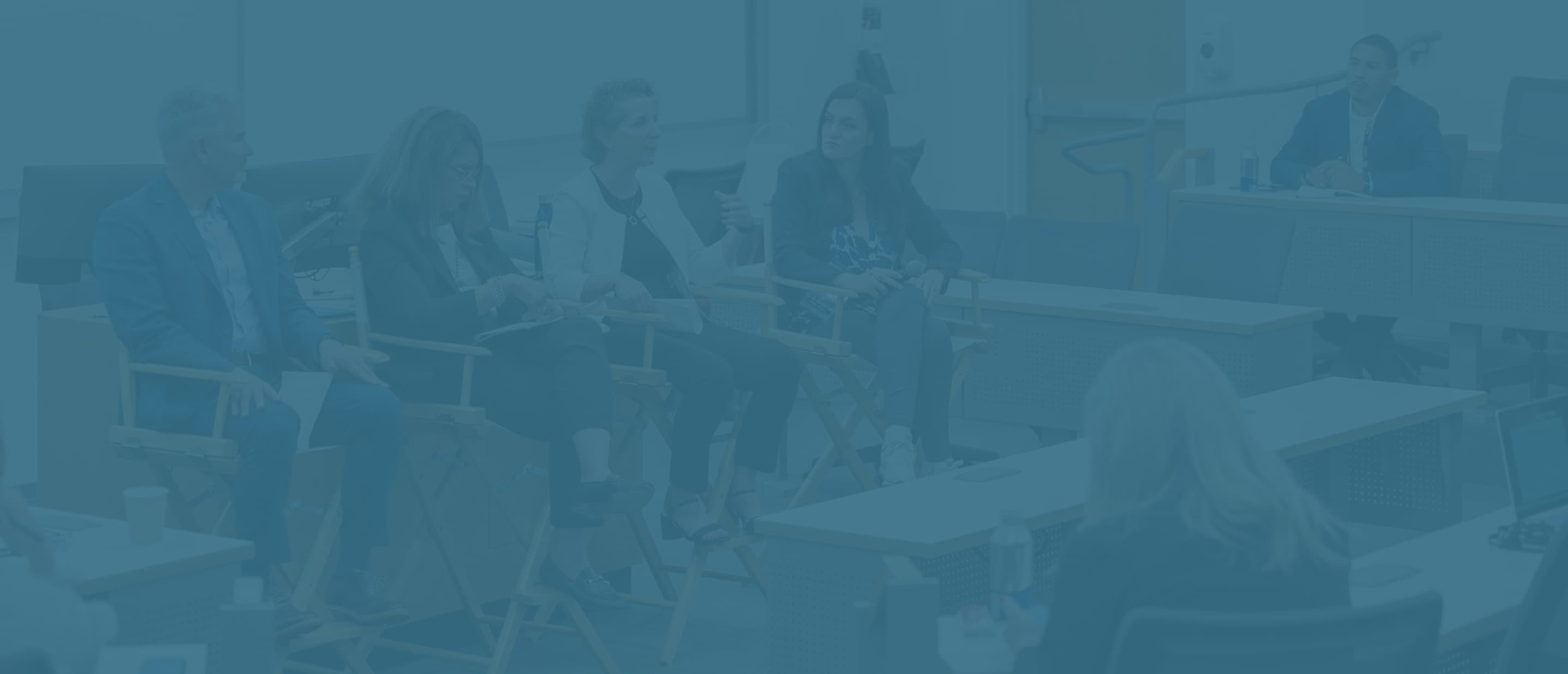 a group of people sitting in chairs in a room